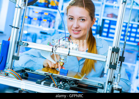 Female Architect Using 3D Printer Stock Photo