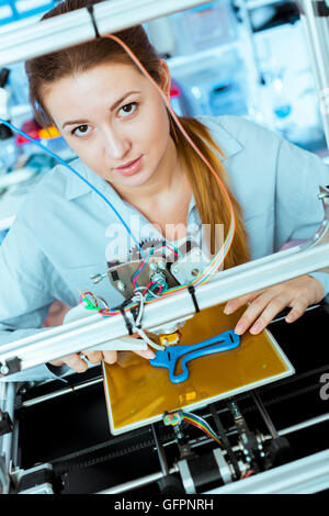 Female Architect Using 3D Printer Stock Photo