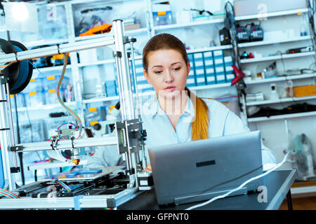 Female Architect Using 3D Printer Stock Photo