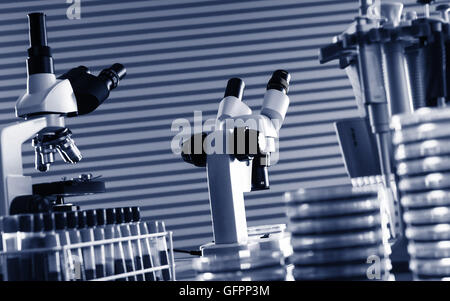 Laboratory work place with microscope, test tube and pipettes. Toned photo Stock Photo