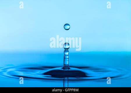 Falling water drop and splash Stock Photo