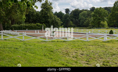 nice view on an empty riding place with white fence Stock Photo