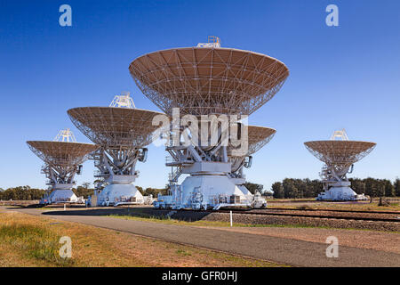 compact australian deep space radio antennae array of 5 dishes mounted on railway platforms observing skies. Science technology Stock Photo