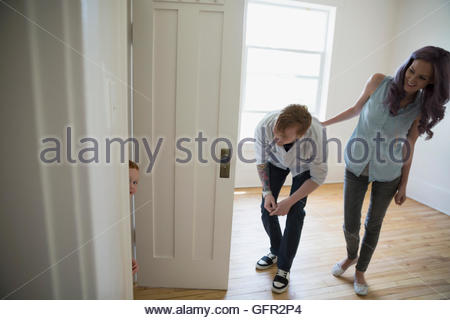 Playful young family in empty new house
