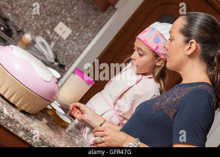 Preparing cupcakes with mom Stock Photo