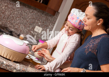Preparing cupcakes with mom Stock Photo