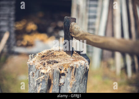 Axe in Piece of Log Wood from Behind Stock Photo