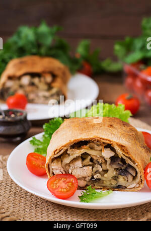 Homemade strudel with chicken, mushrooms, cheese and parsley Stock Photo