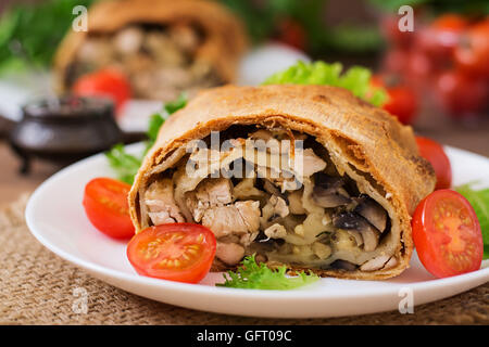 Homemade strudel with chicken, mushrooms, cheese and parsley Stock Photo
