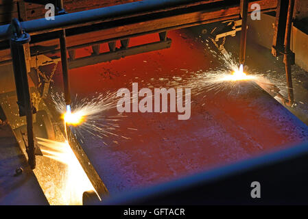 gas cutting steel plate on conveyor Stock Photo