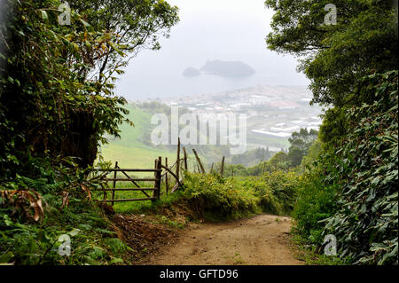 Downhill landscape from the trekking path towards the town Villa Franca in Sao Miguel Island of Azores Stock Photo