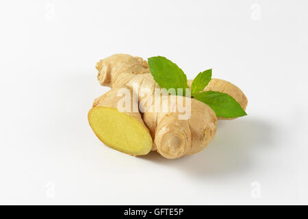 fresh ginger root on off-white background with shadows Stock Photo