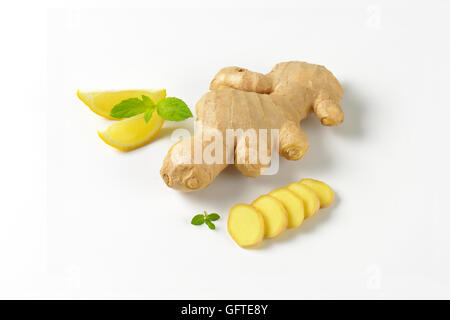 sliced ginger with lemon and mint on off-white background with shadows Stock Photo