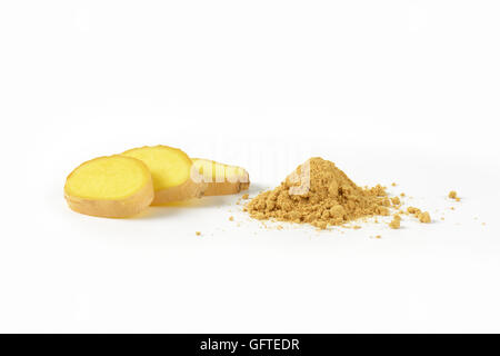 slices of fresh ginger and heap of ground ginger spice on white background Stock Photo