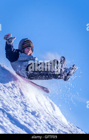 Children sledging at Brighton's Stanmer Park after a pre-Christmas snowfall. Stock Photo