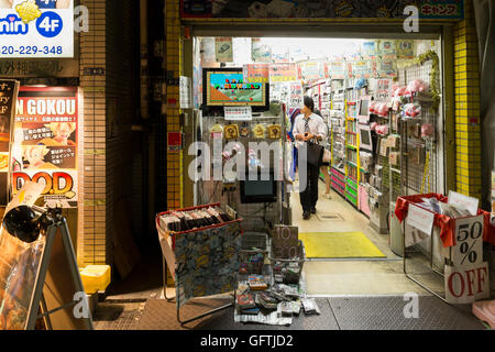 View on a shop window with second hand computer games at night in Akihabara, Tokyo, Japan. Stock Photo