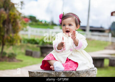 Little baby girl singing happy outdoors Stock Photo