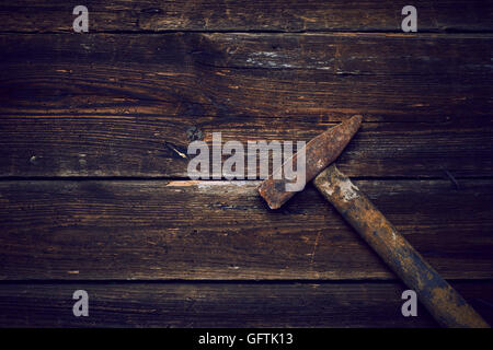 Old steel hammer with wooden handle on the wooden boards background Stock Photo