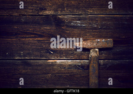 Old steel hammer with wooden handle on the wooden boards background Stock Photo