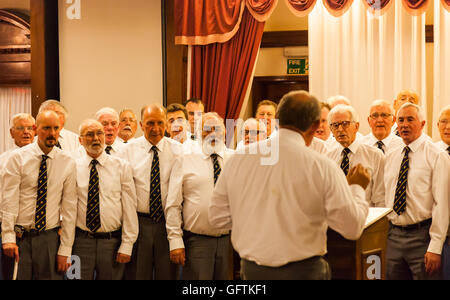 The Cwmbach Male Voice Choir singing at the Fishguard Bay Hotel, Fishguard, Pembrokeshire, Wales Stock Photo