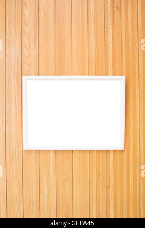 Empty white picture frame on the wooden wall Stock Photo