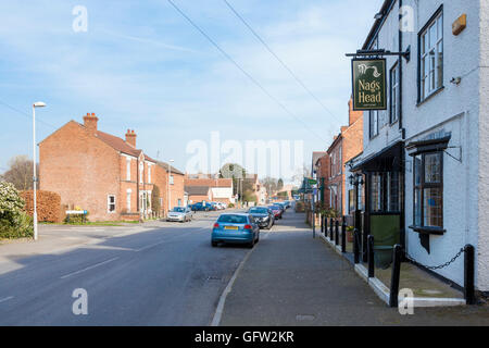Nag's Head pub and the view along Main Street in the village of East Leake, Nottinghamshire, England, UK Stock Photo