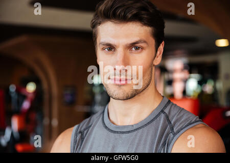 Portrait of confident young man athlete in fitness club Stock Photo