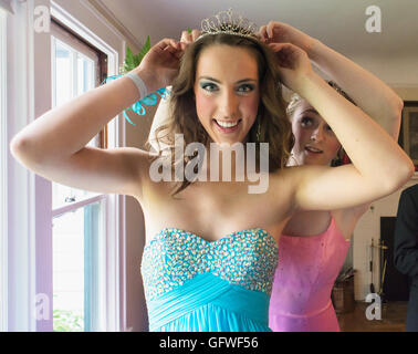 A girl trying on a tiara with her prom dress. Stock Photo