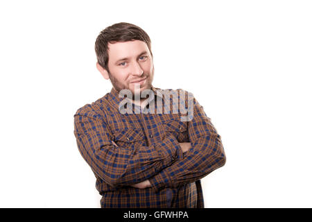 Portrait of a smiling happy handsome middle-aged man with a beard wearing a striped shirt looking at the camera with a warm friendly smile against a white studio background Stock Photo