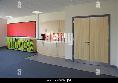 Unfurnished classroom in a brand new primary school. Shows work storage drawers, wet area and large store cupboard Stock Photo