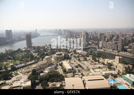 Gezira Island is in the Nile River, in central Cairo, Egypt. The southern portion of the island contains the Gezira District, and the northern third contains the Zamalek District. Gezira Island is west of downtown Cairo and Tahrir Square, connected across the Nile by three bridges each on the east and west sides, including the Qasr al-Nil Bridge and 6th October Bridge. Under 19th century ruler Khedive Ismail the island was first called 'Jardin des Plantes' (French for 'Garden of Plants'), because of its great collection of exotic plants. Stock Photo