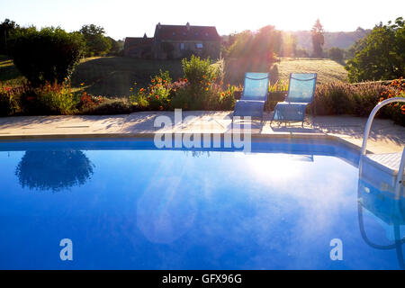 Sunrise over a swimming pool at a gite in Le Lot and Dordogne Regions of France July 2016 Stock Photo