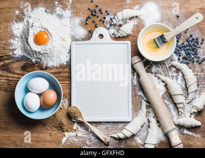 Baking ingredients for cooking croissants with white board in center Stock Photo