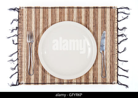 plate and cutlery on a single bamboo isolated on white background. Ideal for add food or text Stock Photo