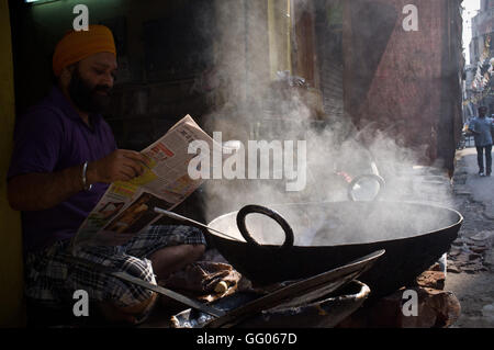 Amritsar, Punjab, India. 12th May, 2013. File Image - An indian food street vendor reads the newspaper early in the morning in Amritsar, India. © Jordi Boixareu/ZUMA Wire/Alamy Live News Stock Photo