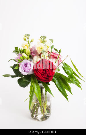 Mixed bouquet of Australian flowers and leaves in a glass jar Stock Photo