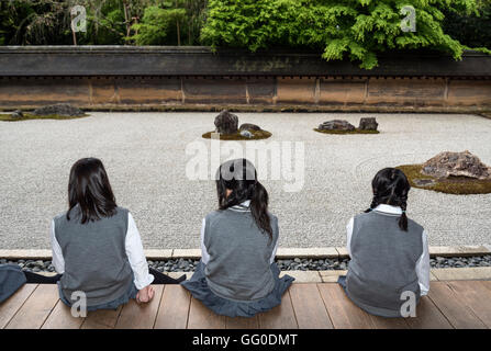 School-girls at zen rock garden, Ryoanji (Ryoan-ji) Temple, Kyoto, Japan Stock Photo