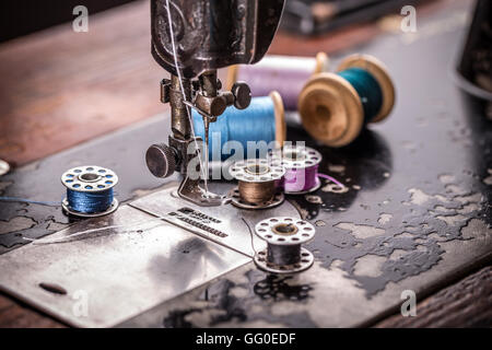Antique sewing machine with spools of thread Stock Photo