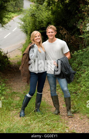 YOUNG COUPLE IN COUNTRYSIDE.  A young couple walking in English countryside Stock Photo