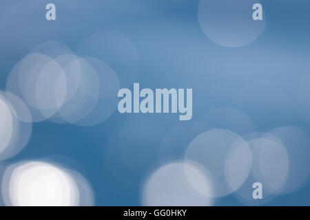 bokeh of light reflections on water as a background in blue colors Stock Photo