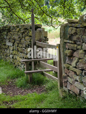 A stile is a structure which provides people a passage through or over a fence or boundary Stock Photo