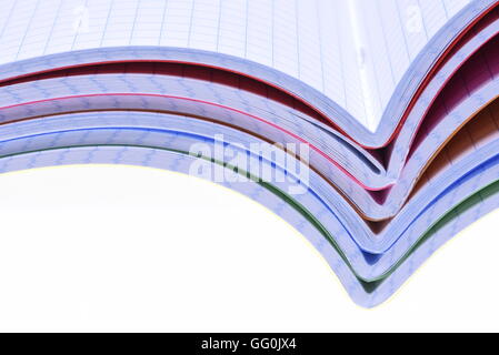 Stack of opened exercise books isolated on white background Stock Photo