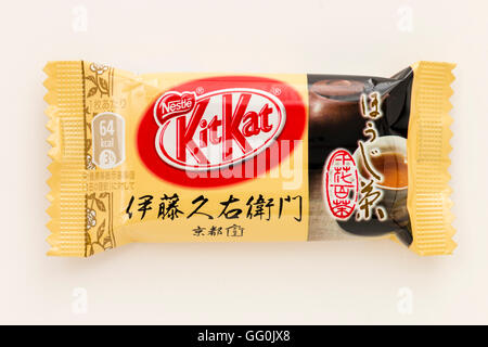 Japanese kitkat. Single wrapped chocolate bar, coffee favour, cream coloured wrapper. Plain background. Stock Photo