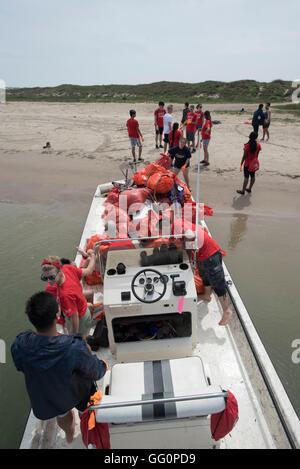 Students from the Univ. of Houston volunteer to help clean up Port Mansfield jetties in south Texas during spring break Stock Photo