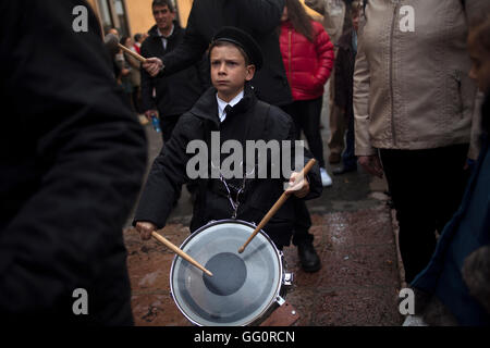 A boy plays a drum during an Easter Holy Week procession in Astorga, Castilla y Leon, Spain. Stock Photo