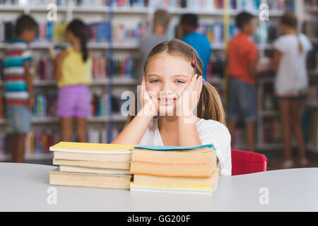 Girl sitting with a pile of books Stock Photo - Alamy