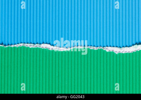 blue and green torn corrugated paper background texture Stock Photo