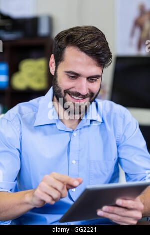 Male therapist using digital tablet Stock Photo