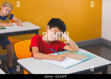 Schoolboy doing her homework Stock Photo