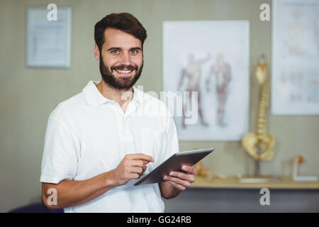Male therapist using digital tablet in clinic Stock Photo